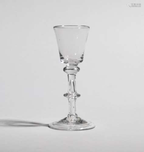 A small wine glass c.1750-60, the bucket bowl raised on a double-knopped balustroid stem enclosing a