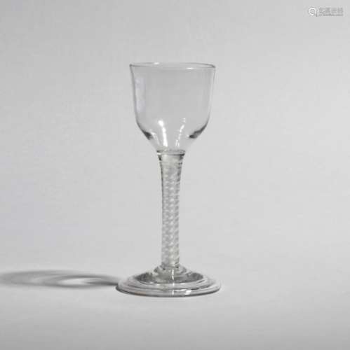 A large wine glass c.1750, the ogee bowl raised on a double series opaque twist stem above a