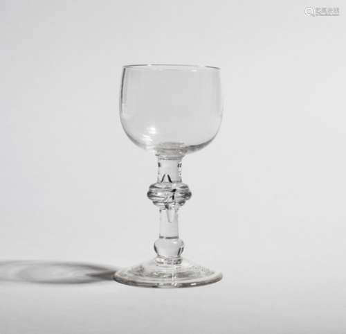 A goblet c.1770, the cup shaped bowl raised on a baluster stem with a triple cushion knop above a
