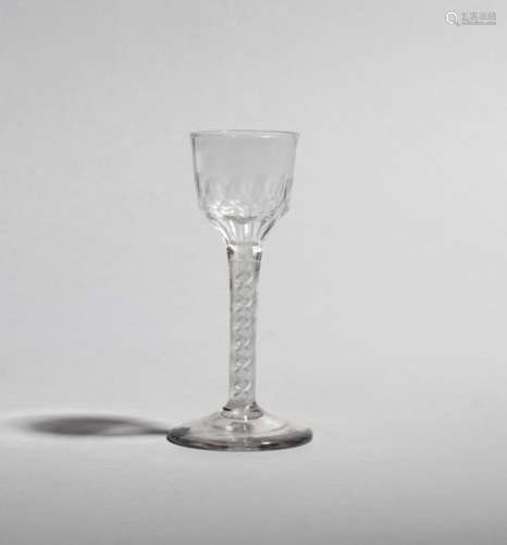 A cordial glass c.1760-70, the ogee bowl cut with petal facets around the base, raised on a double