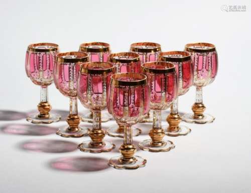 Ten Bohemian glass goblets late 19th/20th century, possibly Moser, the rounded bowls flashed and cut