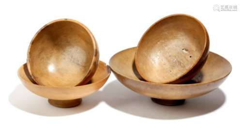 Four Welsh treen sycamore footed bowls, early 19th century and later, 21.8cm diameter (max). (4)