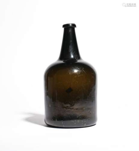 A large wine bottle c.1740, of double magnum size, the mallet form of a deep green metal, rising