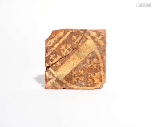 A medieval armorial encaustic tile 14th century, decorated in cream slip on a terracotta ground with