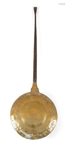 A late 17th century brass warming pan, with an iron handle, the lid pierced and engraved with the