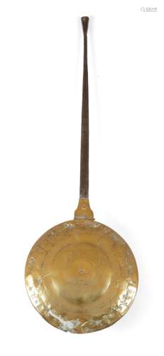 A late 17th century brass warming pan, with an iron handle, the lid pierced and engraved with the