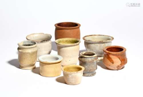 Nine pottery ointment pots 17th century and later, including delftware, variously decorated in tin