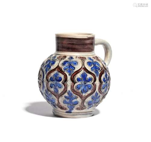 A Westerwald stoneware jug c.1700, the globular body decorated with a formal panelled design of