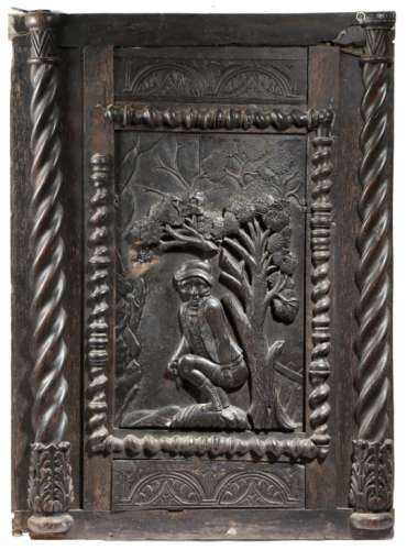 A mid-18th century carved oak panel, depicting a young man caught short, squatting by a tree, with