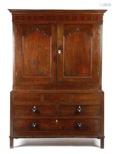 A George III Welsh oak press cupboard, the mahogany frieze above a pair of arc d'arbelète panelled