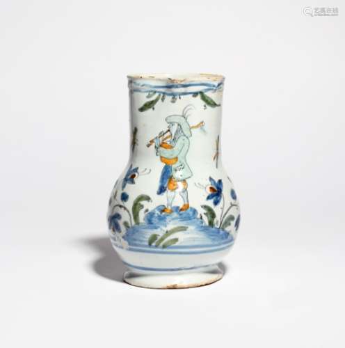 A faïence jug c.1750-70, perhaps Nevers, painted in blue, green, manganese and ochre with a musician