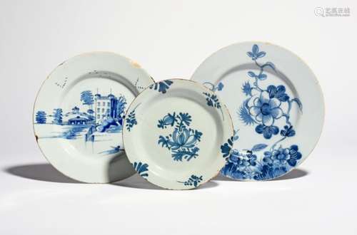 Three delftware plates c.1750-70, one Bristol and painted in blue with an official building beside a