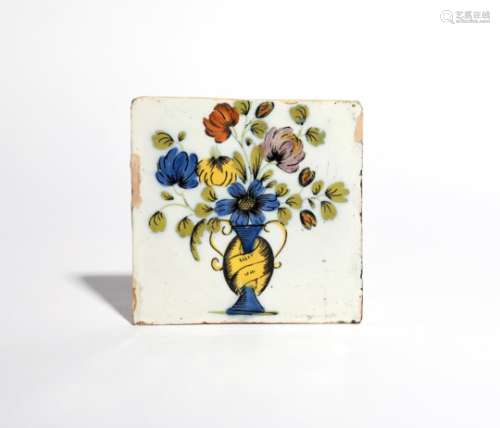A Liverpool delftware tile c.1760, boldly painted in the Fazackerly palette with flowers issuing