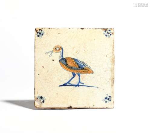 A Delft bird tile c.1640-60, painted in blue and yellow with a duck, depicted with beak agape, the
