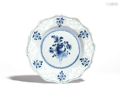 A rare Bristol delftware plate c.1765, painted in blue with an arrangement of flowers including a