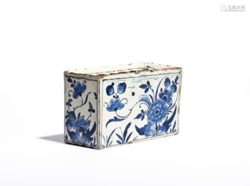 A delftware flower brick c.1760, the rectangular form painted in a deep blue with flowering peony