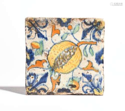 An early delftware pomegranate tile c.1640, probably Rotherhithe, painted in blue, green, yellow and