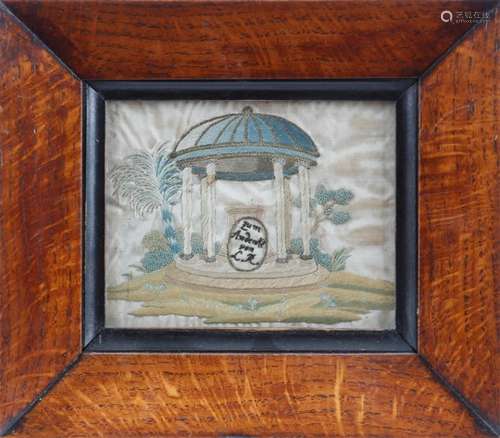 A late 18th century German silkwork memorial picture, depicting a classical temple with a tomb and