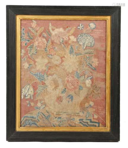 A George II needlework panel by Ann Walker, worked with gros and petit point with an urn of flowers,