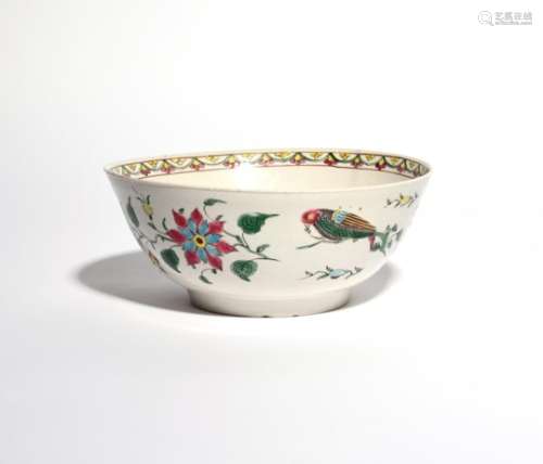 A salt-glazed stoneware punch bowl c.1750-60, brightly enamelled with parrots perched on flowering