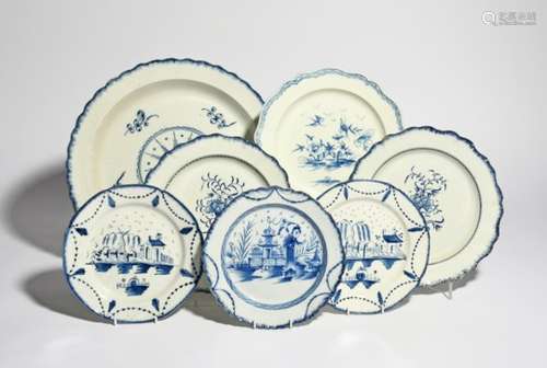 A large pearlware charger and six plates late 18th/early 19th century, variously decorated in blue