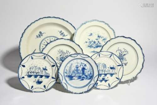 A large pearlware charger and six plates late 18th/early 19th century, variously decorated in blue