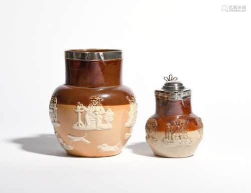 Two brown stoneware silver-mounted jugs c.1867 and later, the smaller sprigged with a toper, a