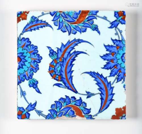 An Iznik pottery tile 2nd half 17th century, the square form brightly enamelled in blue, red and