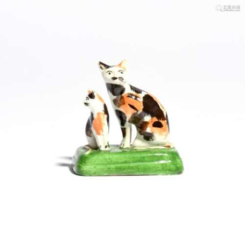 A small Staffordshire porcelain group of cats 1st half 19th century, modelled as a mother cat and