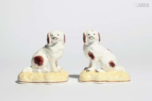 A pair of Staffordshire porcelain models of spaniels c.1840, in the manner of Samuel Alcock, each