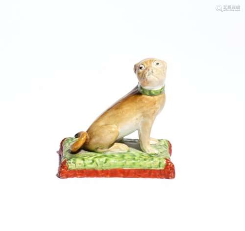 A Staffordshire pearlware figure of a pug dog c.1820-40, seated on its haunches with its head turned