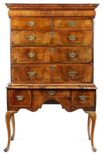 An early 18th century walnut chest on stand, the moulded cornice above a cushion drawer and two