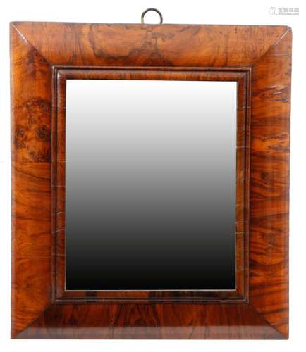 An early 18th century walnut cushion frame wall mirror, the later bevelled rectangular plate