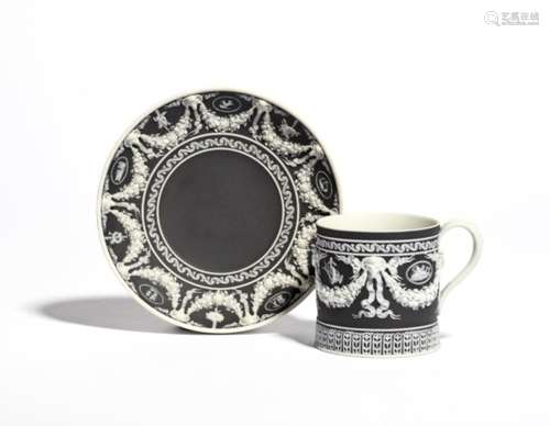 A Wedgwood Jasperware coffee can and saucer 1st half 19th century, finely applied in white on