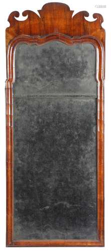 A George I walnut fret-frame wall mirror, with two bevelled plates, within a moulded arched frame