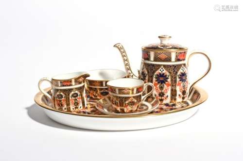 A miniature Royal Crown Derby solitaire tea service modern, richly decorated in a panelled Imari