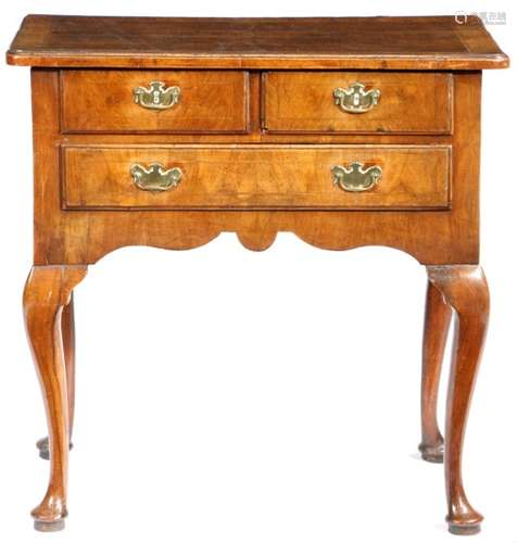 A George II walnut lowboy, cross and feather banded, the quarter veneered top with a caddy moulded