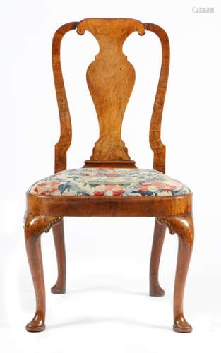 A George I walnut side chair, with a vase shaped splat, above a bell shaped needlework drop-in seat,