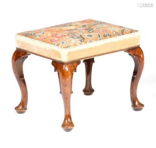 A George II walnut stool, the stuffed-over needlework seat worked with gros and petit point with