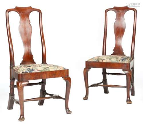 A pair of George II red walnut side chairs, each with a vase shaped splat, above a later tapestry