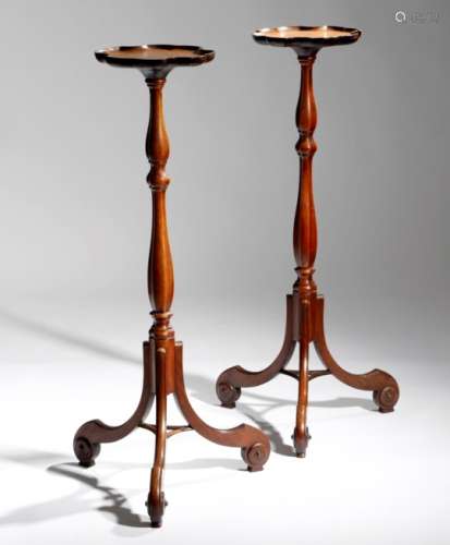 A pair of mahogany candlestands in George II style, each with a dished top with a pie-crust style