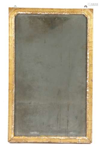 A mid-18th century giltwood wall mirror, the arched bevelled plate within a carved slip and a