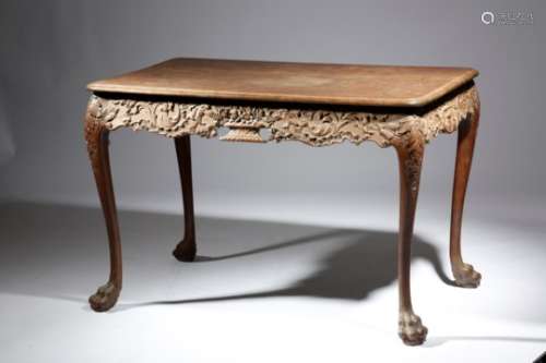An Irish mahogany centre table in George II style, the top with a moulded edge above a profusely