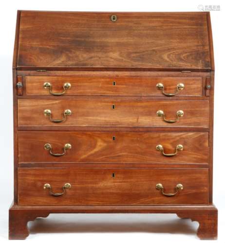 A George III mahogany bureau, the hinged fall revealing an arrangement of pigeonholes, drawers and a