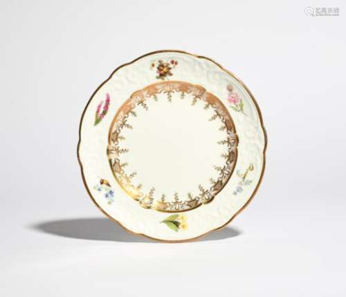 A Swansea plate c.1815-18, the rim with C-scroll moulding, finely painted with single sprays of