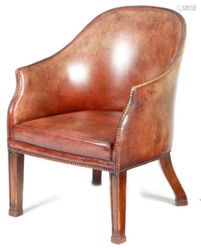 An early 19th century mahogany tub desk chair, covered with later brass studded red leather, on