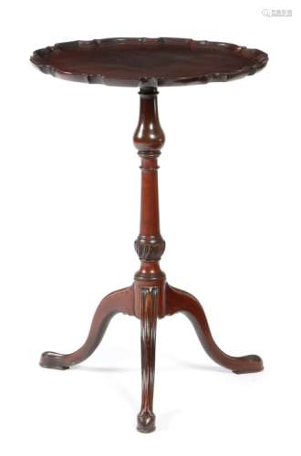 A George III tripod table, the circular fixed top with a pie-crust moulded edge above a turned