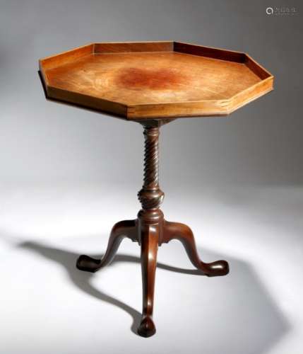 A George III mahogany tripod table, the octagonal tilt-top revolving on a birdcage, the gallery