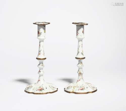 A pair of Staffordshire enamel candlesticks c.1770, the knopped stems rising to cylindrical
