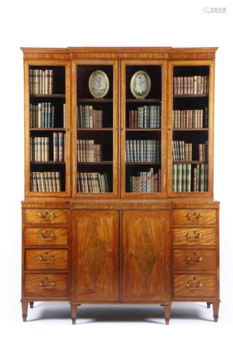 A George III 'Sheraton' satinwood breakfront bookcase, inlaid with stringing and kingwood banding,